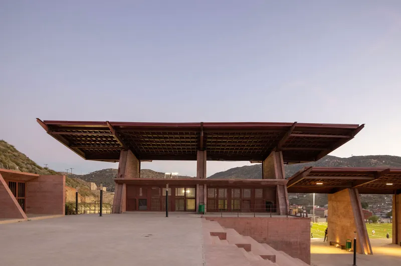 Elevated plaza with cantilevered roof plane and glazed enclosure at the center pavilion