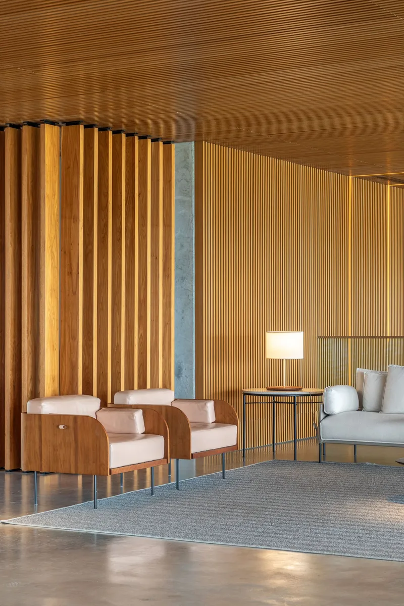 Reception area with vertical timber slat partition and exposed wood plank ceiling