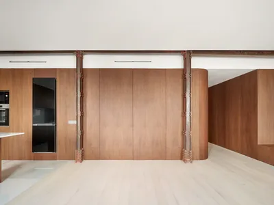 Pulso Arquitectos Carves a Madrid Apartment Around Exposed Steel Columns and Walnut Millwork