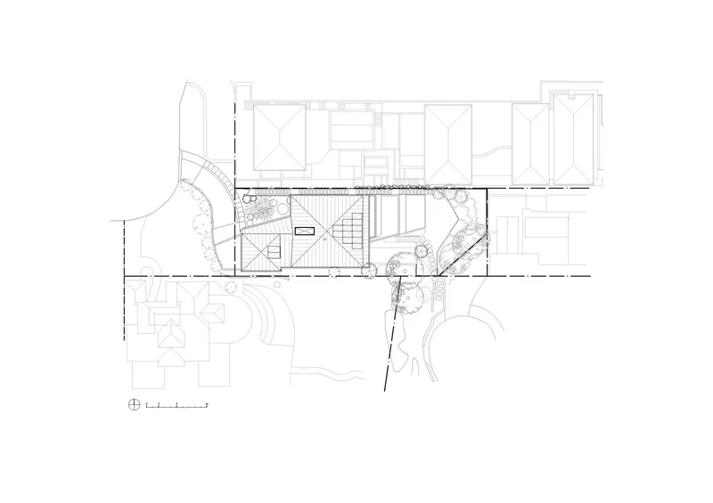 Floor plan showing central staircase with flanking planted courtyards and adjacent rooms