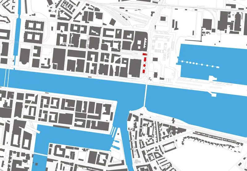 Site plan drawing showing building footprints along a waterfront with a highlighted intervention in red