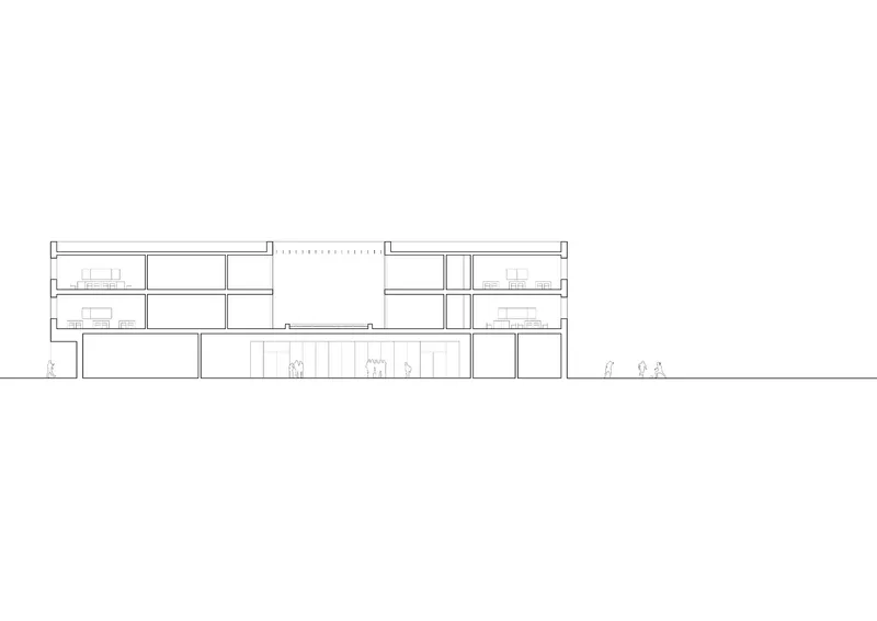 Section drawing revealing three-story building with double-height auditorium and human figures for scale
