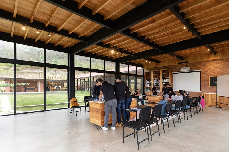 Interior event space with exposed timber joists and steel beams above polished concrete flooring