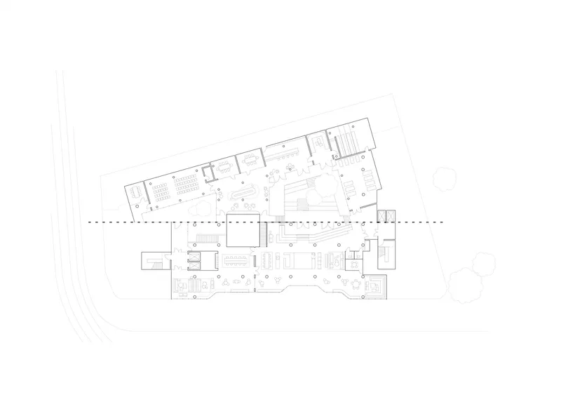 Floor plan drawing showing an angled two-wing layout with central circulation spine