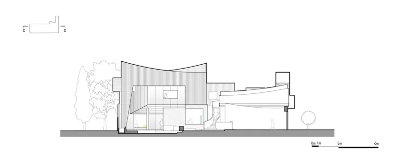 Section drawing revealing interior spatial relationships beneath a curved roof with flanking vegetation