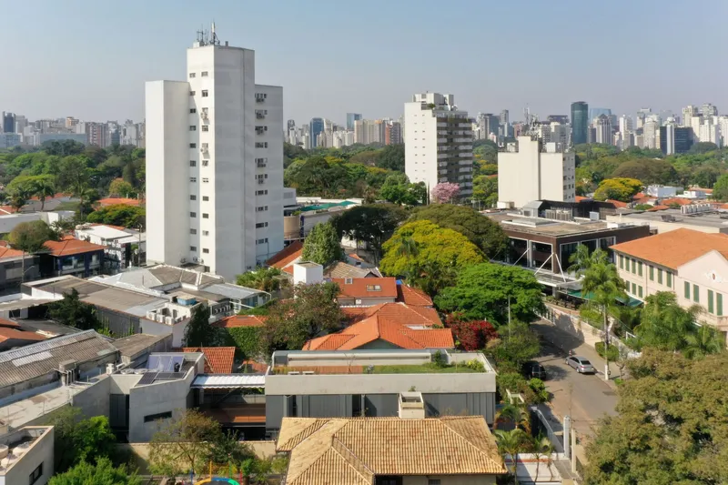 Elevated view of the residence with flat roof terrace amid dense urban neighborhood