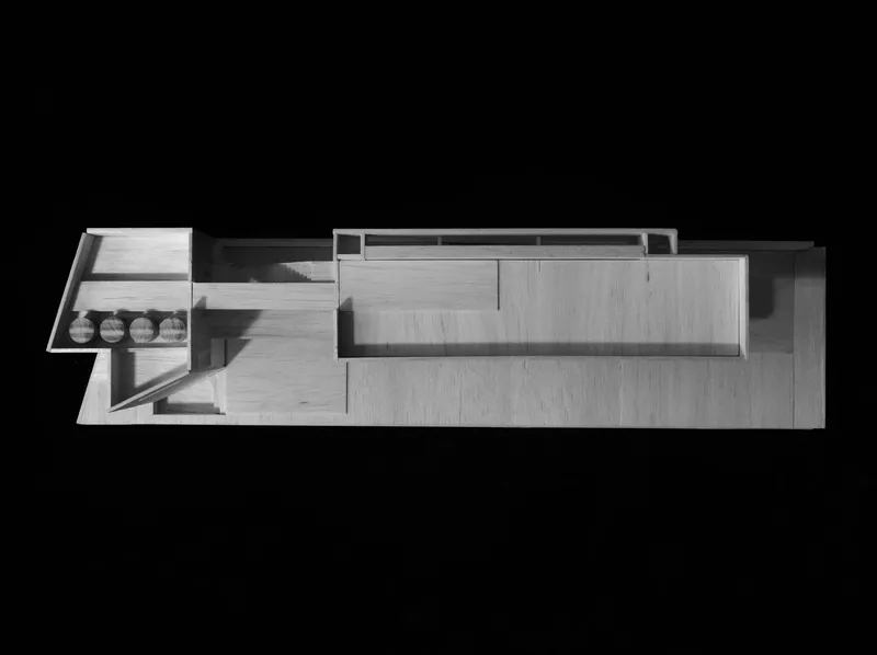 Physical model showing a top view of interlocking volumes with stepped terraces and courtyard