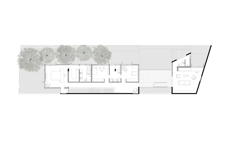 Upper floor plan drawing showing bedroom wing with bathrooms and angled rear terrace with tree canopies