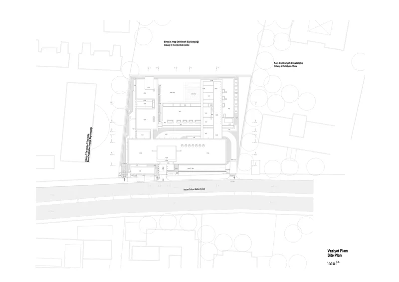 Site plan drawing showing the rectangular complex with central courtyard and surrounding street trees