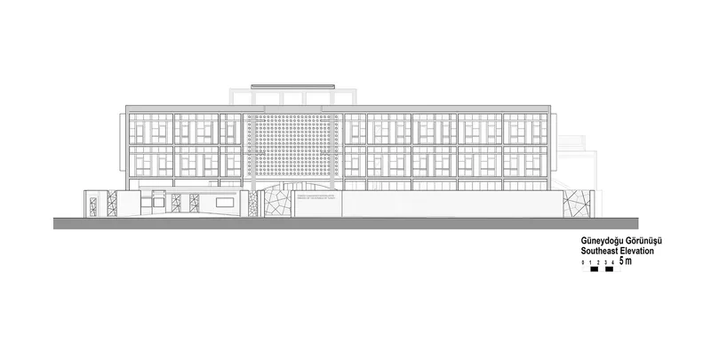 Elevation drawing of the long symmetrical facade with gridded brick infill and central perforated screen