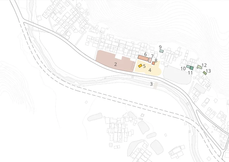 Site plan drawing with colored volumes indicating building footprints along a curved roadway and topographic contours