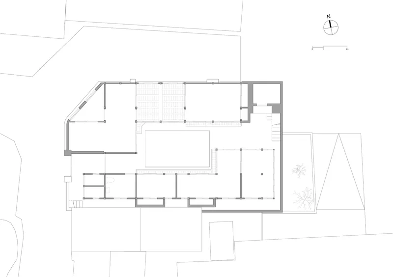 Floor plan drawing showing an L-shaped layout with a central courtyard and multiple rooms
