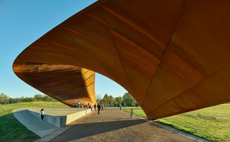 Underside of the laminated timber roof showing structural panels and column with visitors below