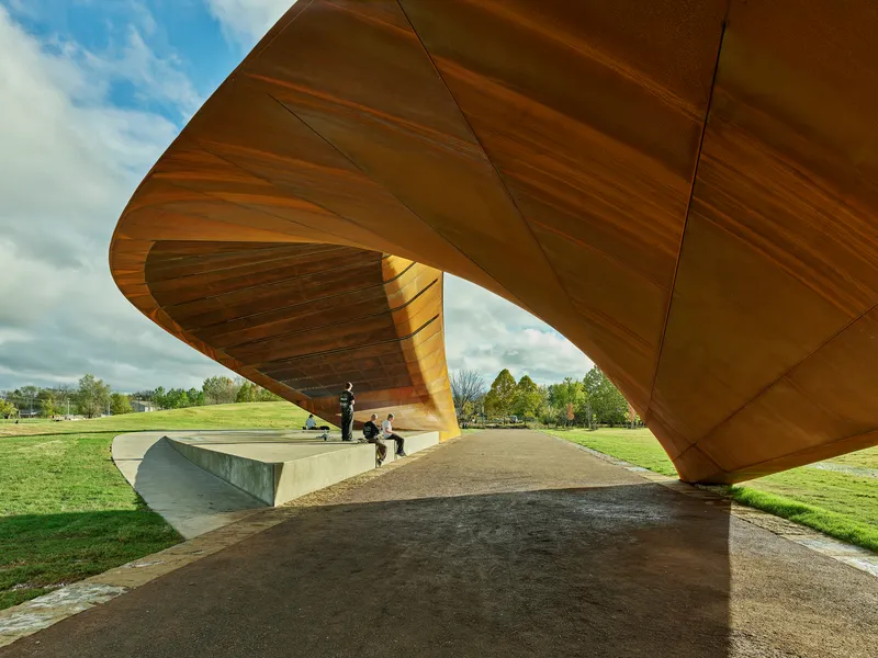 Underside of the warped steel panels and structural ribs viewed from beneath the canopy opening