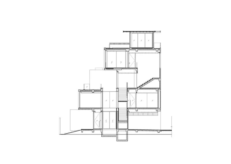 Section drawing revealing a central staircase connecting offset floor levels across the building height