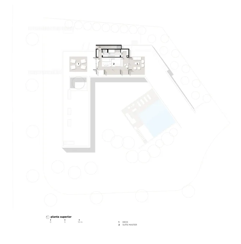 Floor plan drawing showing an L-shaped upper level with a master suite and detached pool volume