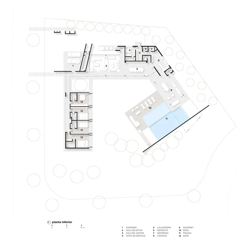Floor plan drawing showing angled wings with living areas and pool surrounded by circular trees