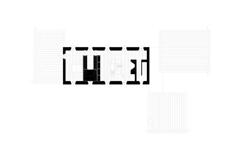 Floor plan drawing showing a compact rectangular volume with central kitchen and surrounding terraces