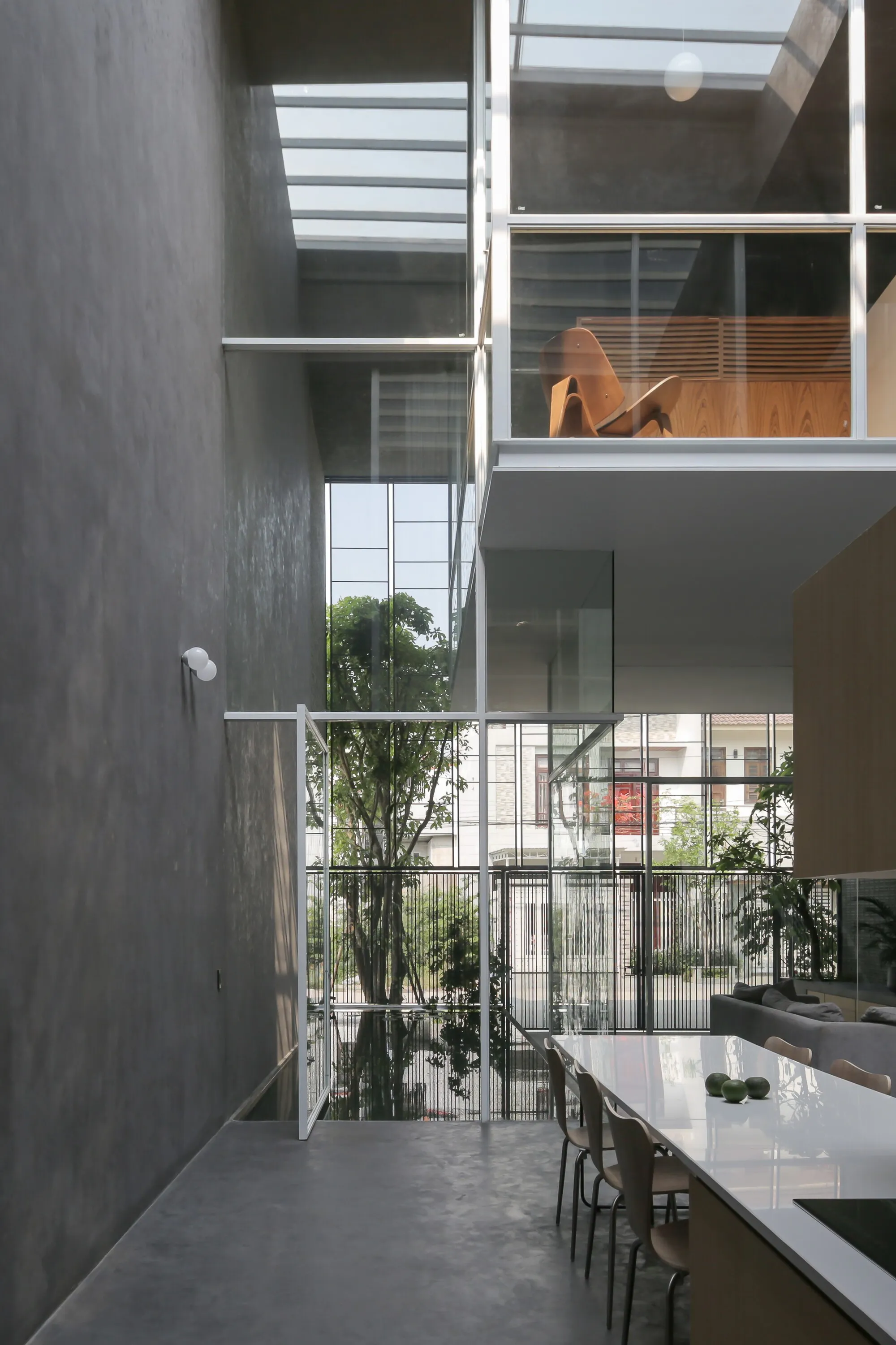 BHA Studio Suspends Glass Living Pods Inside a Nine-Meter Concrete Shell in Hue, Vietnam