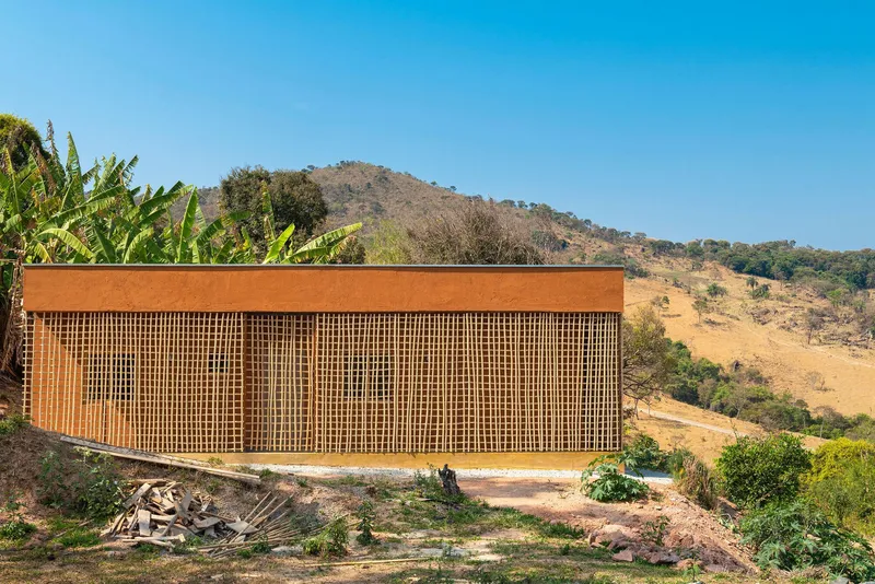 Long view of the slatted timber screen facade spanning the full length of the volume