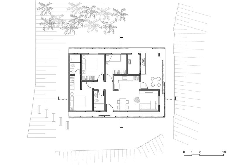 Floor plan drawing showing rectangular dwelling with bedrooms, kitchen, and dining adjacent to palm trees