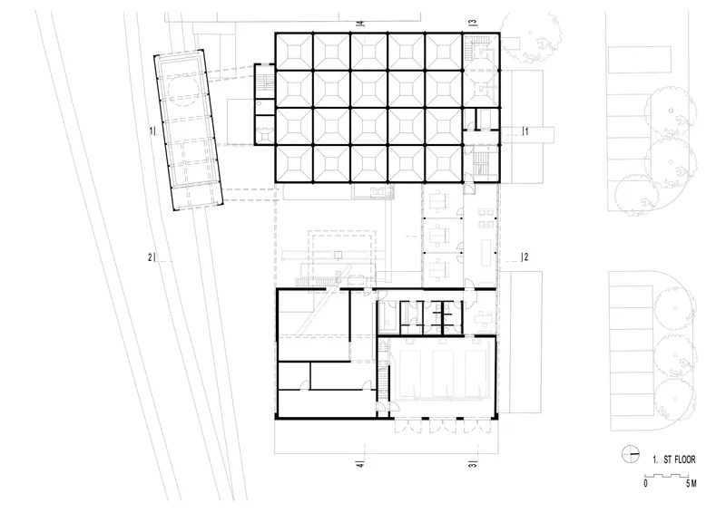 First floor plan drawing showing gridded workspace, loading area, and support rooms