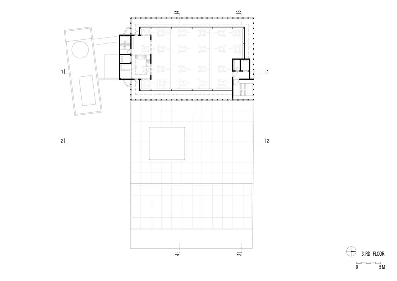 Third floor plan drawing displaying gridded exterior surfaces and enclosed interior zones with furnishings