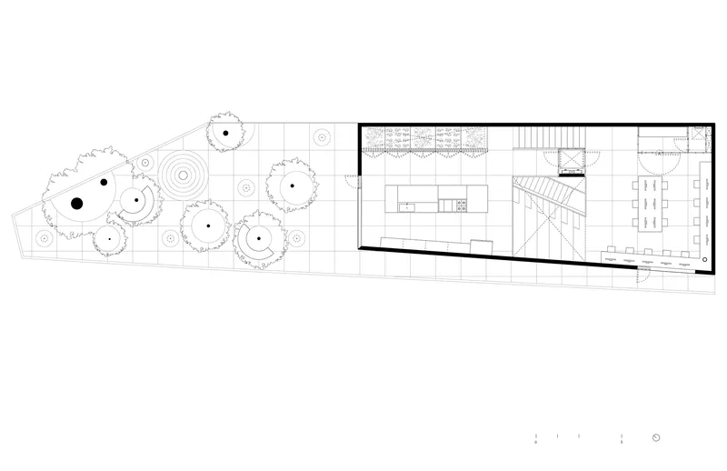 First floor plan showing open kitchen and living areas with staircase and adjacent courtyard garden