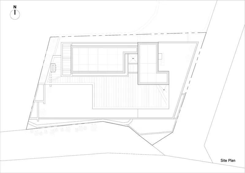 Site plan drawing showing a rectangular building with pool and deck on an angled trapezoidal lot