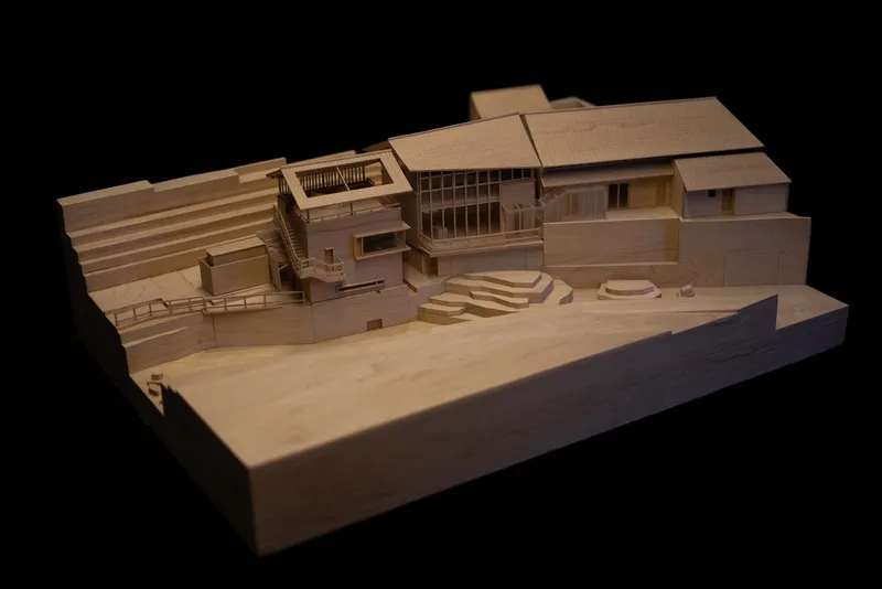 Physical model showing the building volumes and terraced landscape on a sloped site