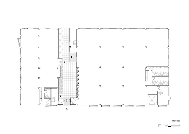 Ground floor plan drawing showing two rectangular volumes connected by a central zigzag stairwell