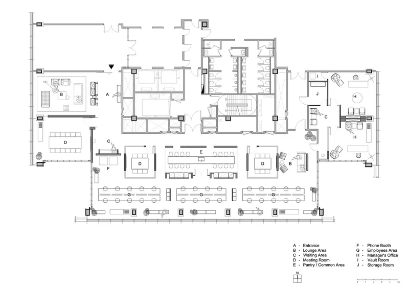 Floor plan drawing showing open office workspace with meeting rooms and support areas along the perimeter