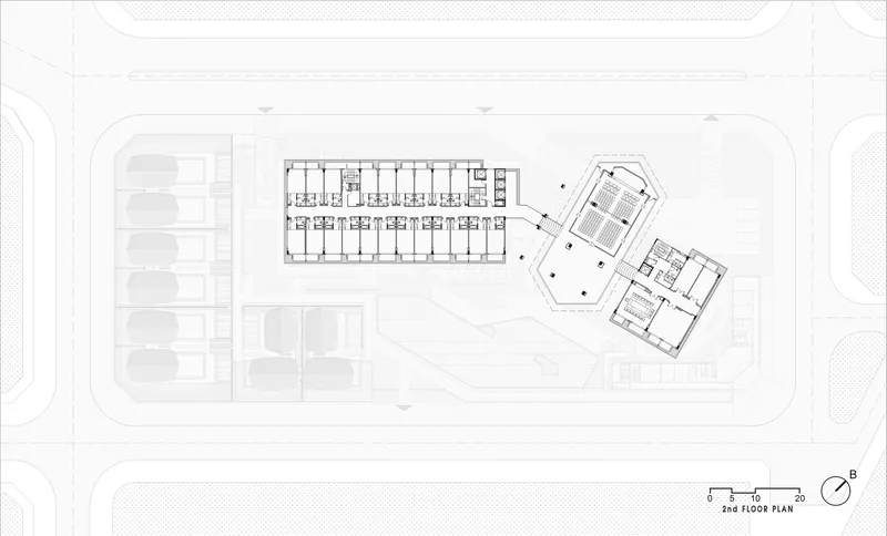 Second floor plan showing a rectangular bar and angled pentagonal wing connected by a glazed circulation node
