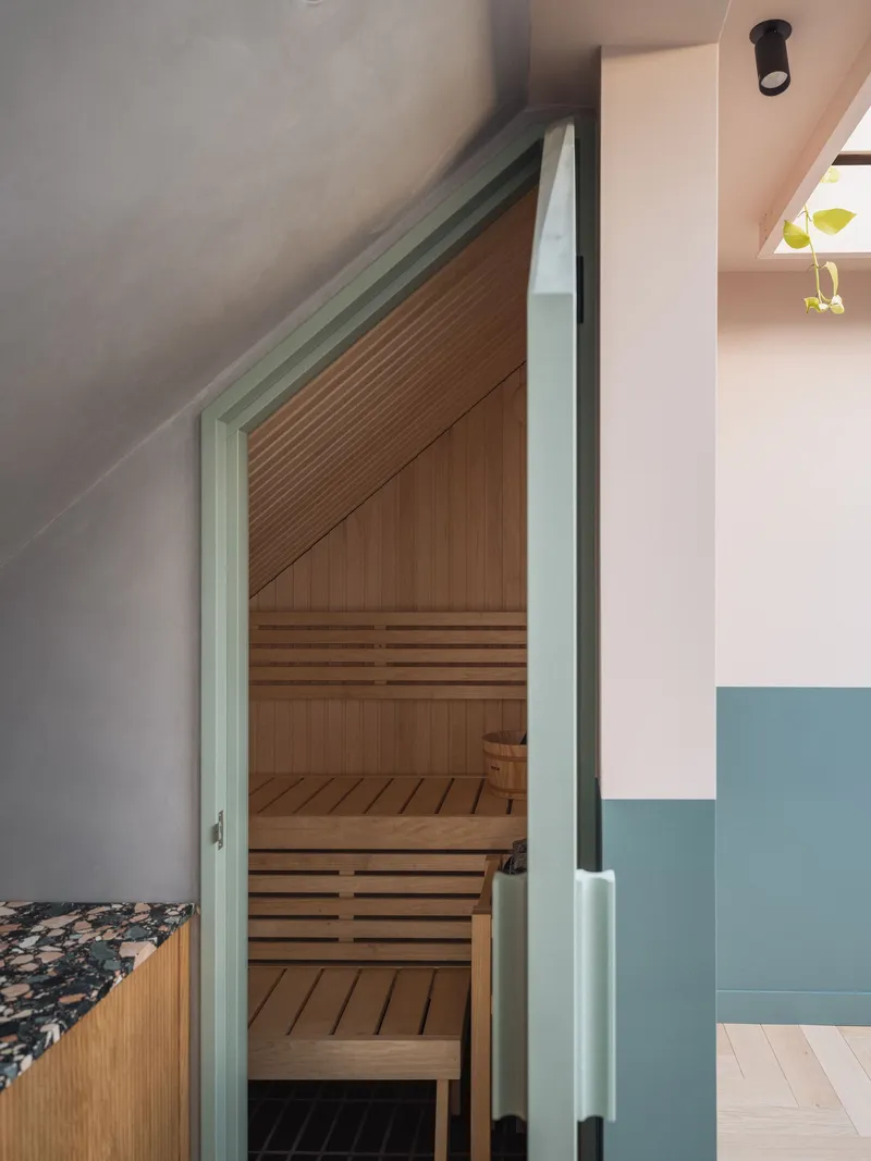 Timber sauna with slatted benches tucked under a sloped ceiling