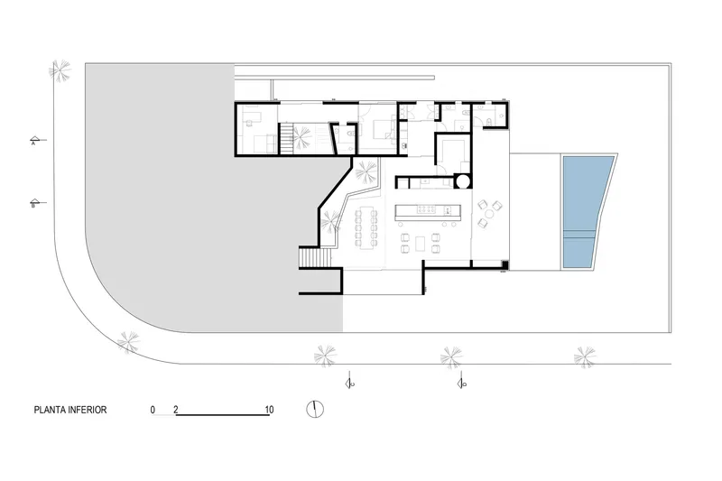 Ground floor plan drawing showing open living areas and angled circulation path adjacent to pool