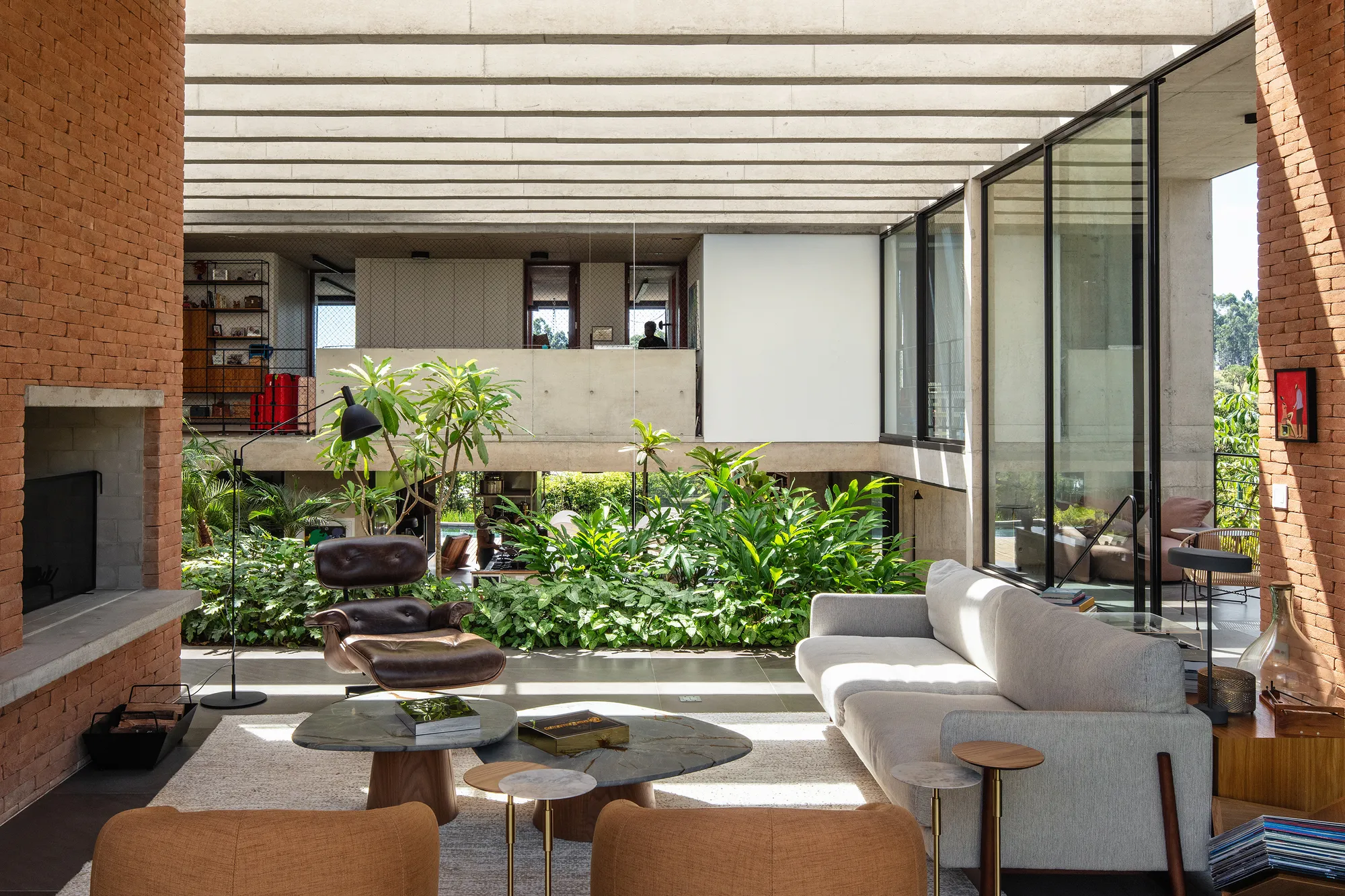 Obra Arquitetos Carves a Lush Internal Void into a Monolithic Brick House in Jundiaí