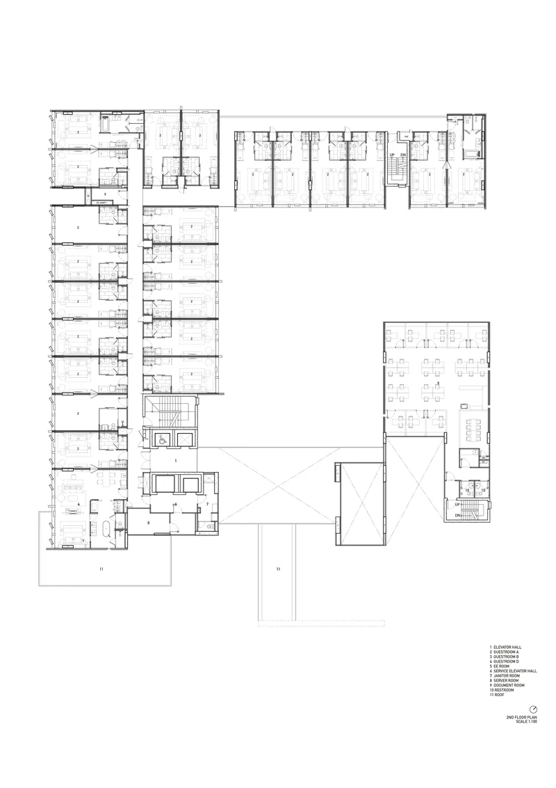 Second floor plan showing residential wings arranged around a central void