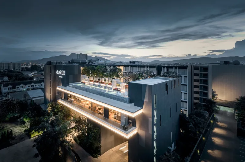 Aerial view of the illuminated rooftop terrace and horizontal light band at dusk