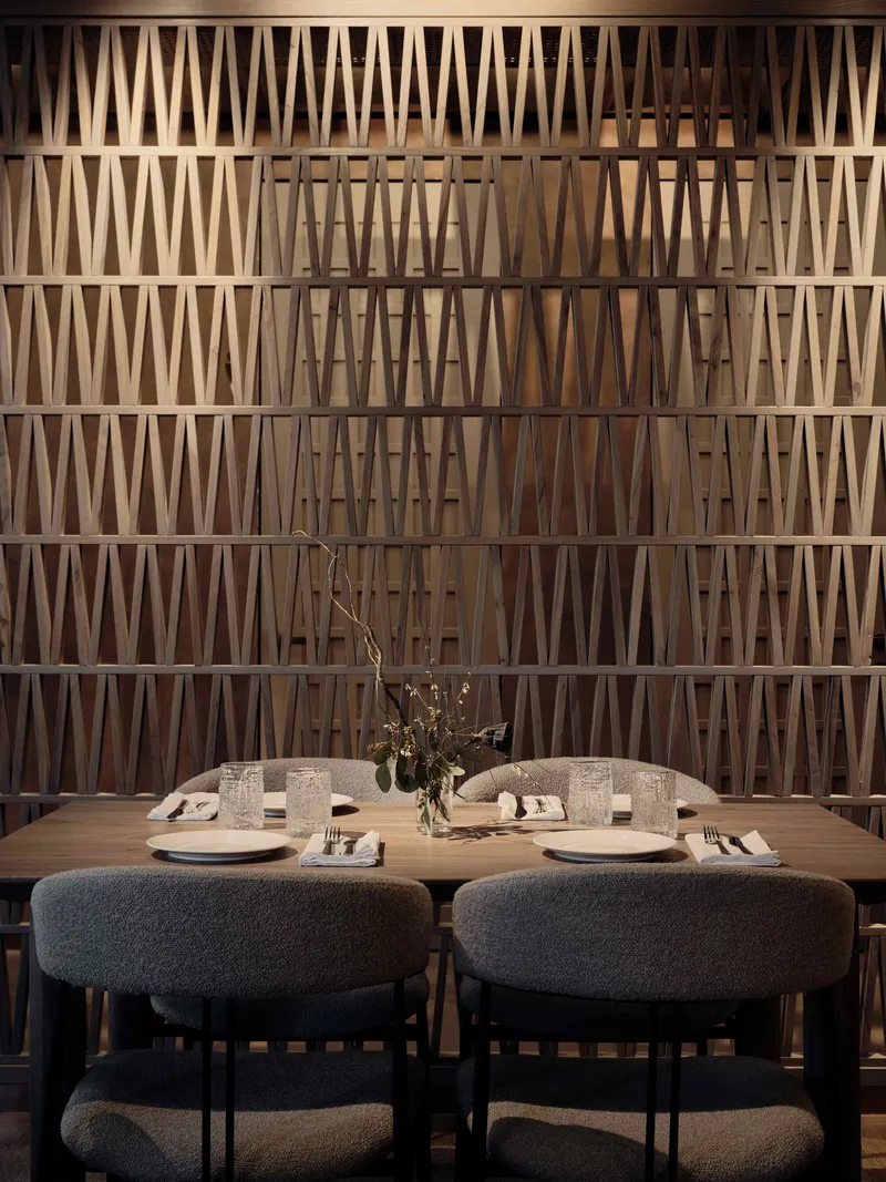 Dining banquette against a latticed timber screen wall with triangular geometric pattern
