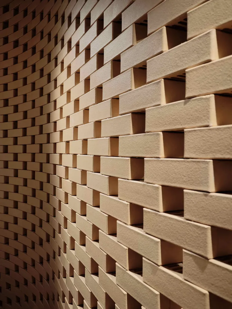 Close-up of staggered timber brick wall creating a basketweave pattern with recessed shadow gaps