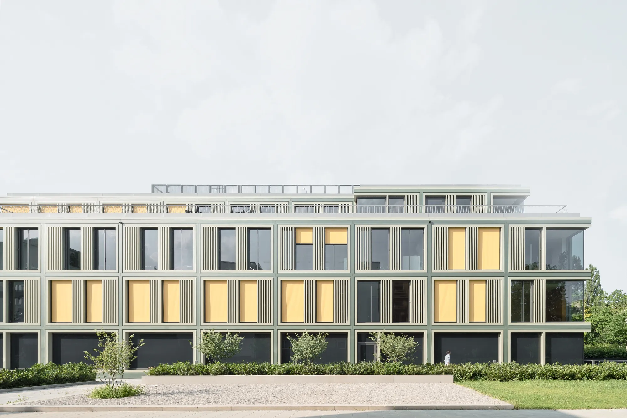 allmannwappner Strips a 1971 Munich Office Block Back to Its Bones and Gives It a Crisp Glass Skin
