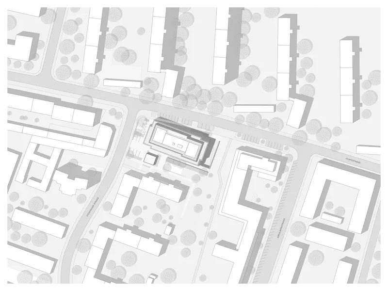 Site plan drawing showing rectangular building volumes arranged along curved streets with rows of trees