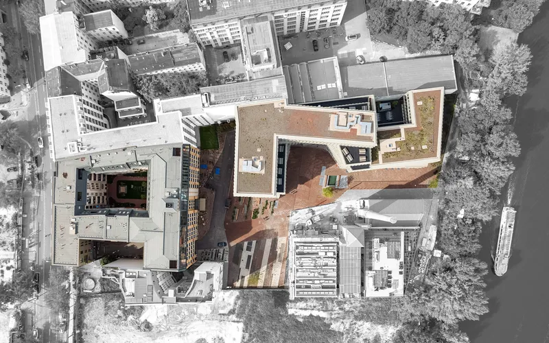 Drone view of the same roof courtyard and neighboring blocks in winter snow