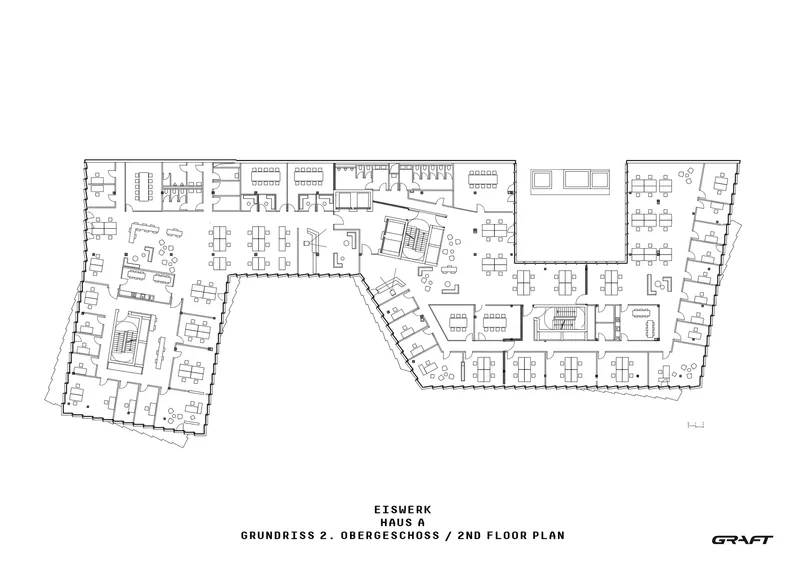 Second floor plan drawing showing office workstations and meeting rooms arranged along angled perimeter wings