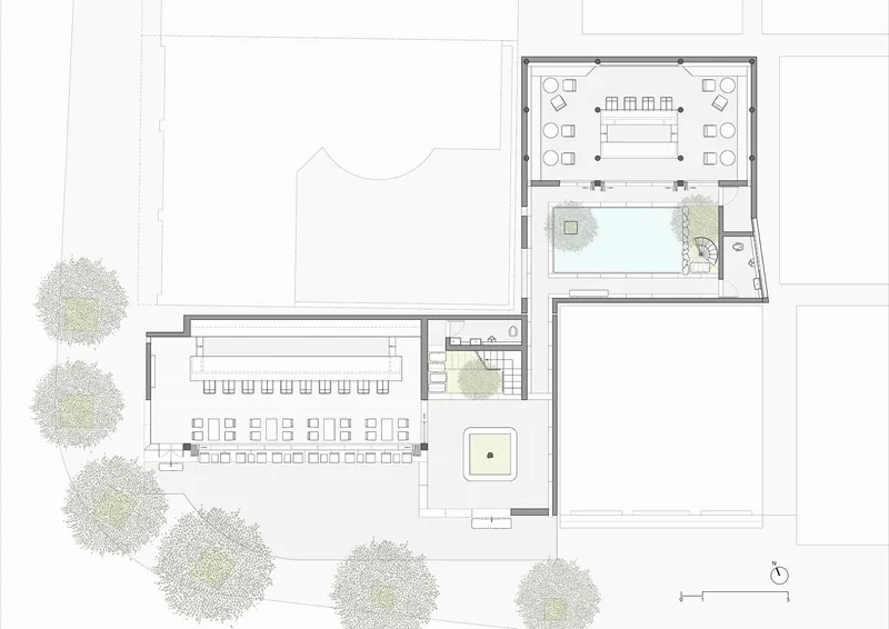 Floor plan drawing showing interconnected rectangular volumes with courtyards and surrounding trees
