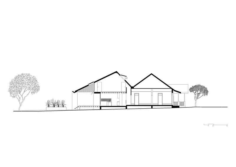 Elevation drawing showing two gabled volumes with flanking trees and ground line