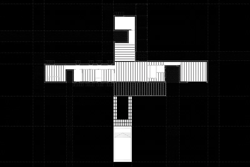 Floor plan drawing showing a cruciform layout with vertical tower element and linear wings