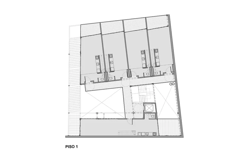 Floor plan drawing showing a first-floor layout with four rental units and a central stairwell core