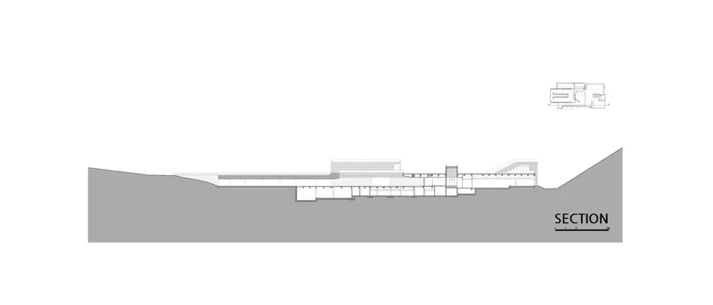 Section drawing revealing interior spaces stepping down through the sloped terrain