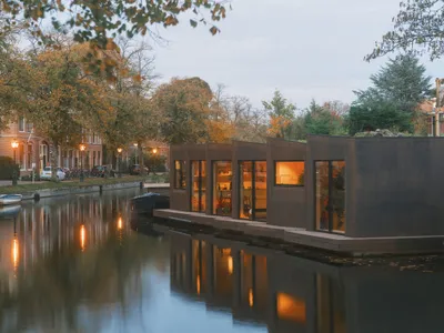 Studio RAP Folds an Origami-Inspired Floating Home from Timber and Cork on a Leiden Canal